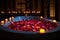 candlelit bath with colorful petals floating on top