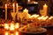 candlelit table with appetizers and drinks at an evening event