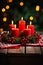 A Candlelit Table with Red Berries and Greenery