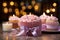 Candles aglow on cupcake, pink ribbonwrapped gift a joyous birthday scene