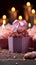 Candles aglow on cupcake, pink ribbonwrapped gift a joyous birthday scene