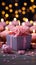 Candles aglow on cupcake, pink ribbonwrapped gift a joyous birthday scene