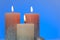 Candles background. shiny candles on a blue background.Burning beautiful candles.Religion and culture