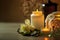 Candles and black hot stone on wooden background. Hot stone massage setting lit by candles. Massage therapy for one person with