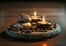 Candles and black hot stone on wooden background. Hot stone massage setting lit by candles. Massage therapy for one person with