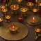 candles in brass candlesticks on a dark wooden background for Diwali celebration by ai generated
