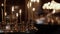 Candles burn in an Orthodox church. Wax candles burn in the dark in church against dark background close-up camera movement.