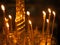 Candles burning on the altar of the church chandelier of an Orthodox church with blurred details