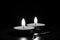 Candles burning in the black background. Black and white photo