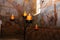 Candles burning on black candleholder inside ancient fresco wall