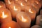 Candles burning brightly. Modern memorial candle on batteries in church. Abstract background