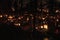 Candles flames illuminating a cemetery at night before `All Saint`s Day` or Day of the Dead festival