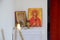 Candles in front of icons in the Orthodox church. A burning wax candles, cross and icons in monastery. Christian religion. Altar i