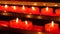 Candles inside a catholic church on a candle rack.