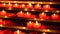 Candles inside a catholic church on a candle rack.