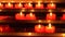 Candles inside a catholic church on a candle rack.