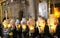 Candles and pilgrims at The Stone of Unction in The Church of the Holy Sepulchre
