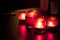 Candles in red glass chandeliers.