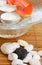 Candles, roses petals in bowl and stones on bamboo