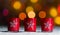 Candles standing in snow with defocussed fairy lights, orange or golden bokeh in the background