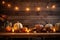 Candles And String Lights Illuminate Rustic Table Adorned With Pumpkins, Creating Warm Thanksgiving Ambiance