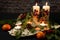 Candles and tangerines on a slice of oak close-up. Spruce branches