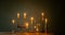 Candles in vintage candlesticks on dark background