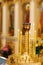 Candlestick in church, burning candles fire, cathedral interior