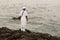 Candomble admirers are seen on top of a rock on the beach, paying homage to Iemanja with gifts