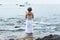 Candomble admirers are seen on top of a rock on the beach, paying homage to Iemanja with gifts