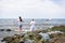 Candomble people are in the water on the rocks of Rio Vermelho beach, offering gifts to Yemanja