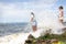 Candomble people are in the water on the rocks of Rio Vermelho beach, offering gifts to Yemanja