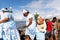 Candomble supporters walk on top of the rocks on Rio Vermelho beach to offer gifts to Yemanja