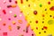 Candy assorted layout. Layout with candy on a yellow-pink background. Chewy marmalade and small caramels . Bright background.