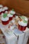 Candy bar. Delicious desserts, berry mousses decorated with whipped cream and berries in glass cups.