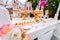 Candy Bar. White decorated wooden trolley with sweets close-up. White wooden trolley.