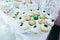 Candy bar. White festive table with deserts,tartlet and cupcakes. Wedding. Reception Tartlets