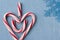 Candy Cane Heart Symbol on Blue Wood with Snowflake Upper Right Side