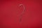 Candy cane question mark on red background. Christmas striped candie