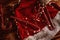 Candy canes on a red Christmas hat among garlands on a wooden table top view