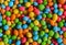 Candy confection background with small green, yellow, red colors. Bright texture and round forms of sweets