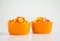 Candy corn in two orange bowls on white
