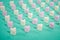 Candy of different colors on a turquoise background, a heart texture on Valentine's Day