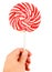 Candy pink spiral lollipop in hand