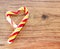 Candy in the shape of heart on a wooden background for the celebration of Valentine`s Day. Heart is broken. Cheating