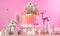 Candyland children`s party Christmas cake in pink and gold table setting.