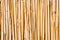 Cane wall. Vertical pipes in natural colors