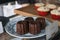 Caneles de bordeaux in white plate on wooden table. Traditional French sweet dessert