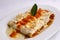 Canelones Italian Dish Bolognese style (caneloni). tomatoes sauce, bechamel, grounded beef meat, basil