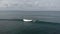 Canggu, Bali, Indonesia - June 15 2023: Aerial view of ocean surf spot with surfers on surfboards catching wave at sunny